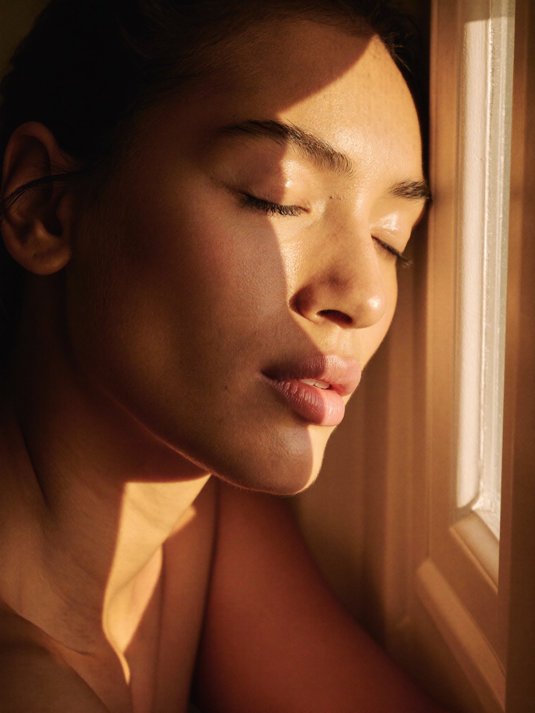 A woman's face in warm morning light